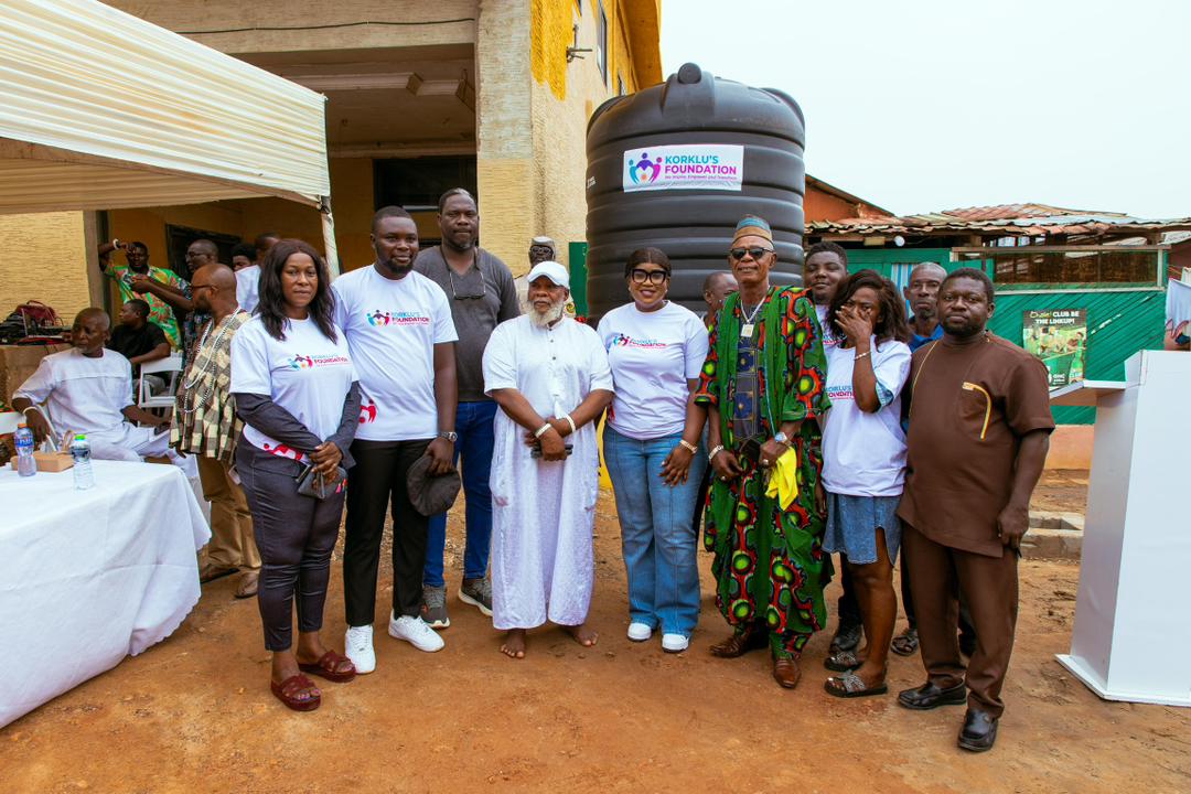 Community representatives beside the Foundation-supported water tank at Apkeshika
